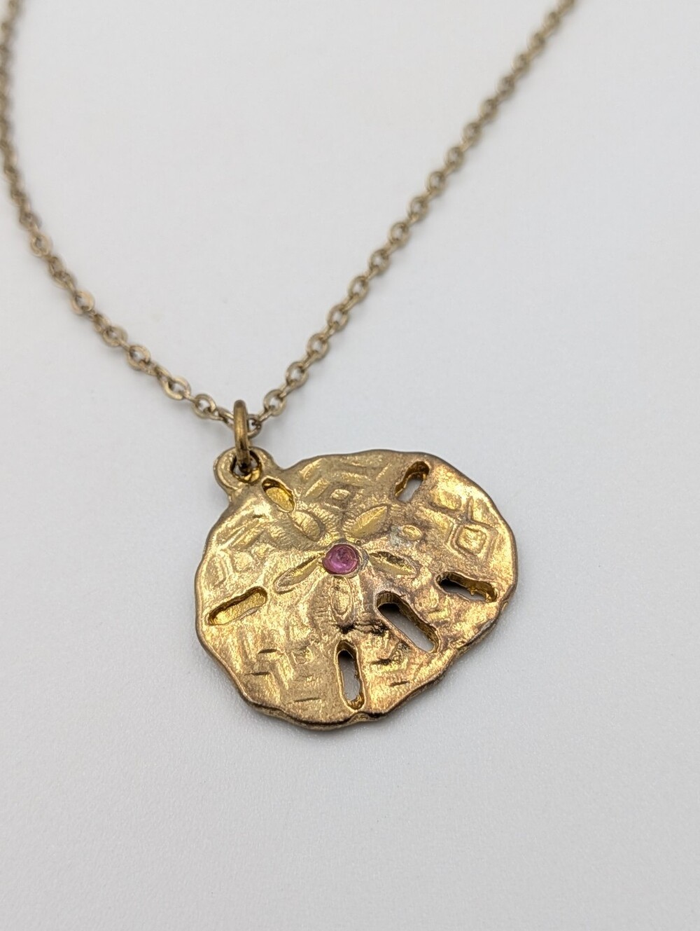 Gold Sand Dollar Pendant Necklace with Pink Accent